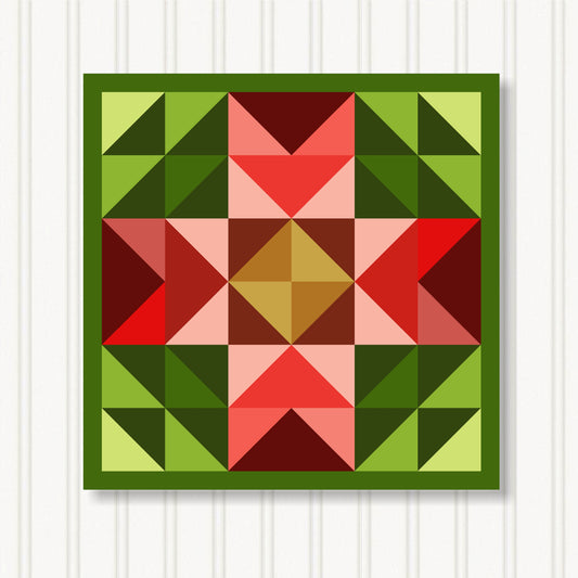 The image is a vibrant and colorful quilt with a geometric pattern of triangles in various shades of green, red, and brown.
