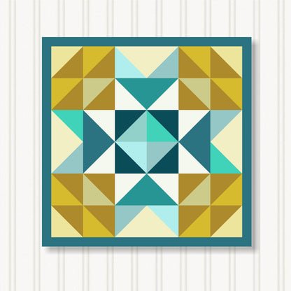The image is a vibrant and colorful quilt with a geometric pattern of triangles in various shades of yellow, blue, and green. The quilt is framed by a blue border and is displayed against a white background.