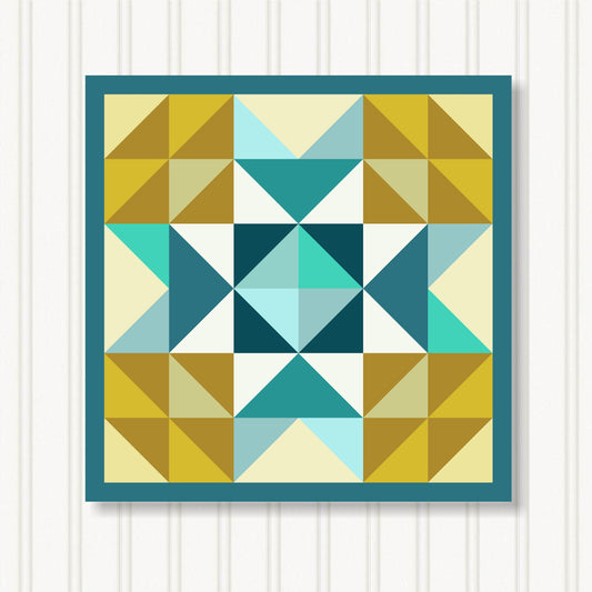 The image is a vibrant and colorful quilt with a geometric pattern of triangles in various shades of yellow, blue, and green. The quilt is framed by a blue border and is displayed against a white background.